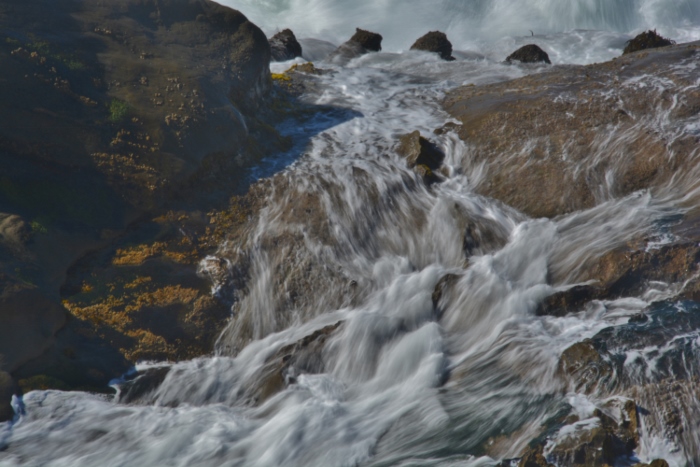 slow motion waves over rocks